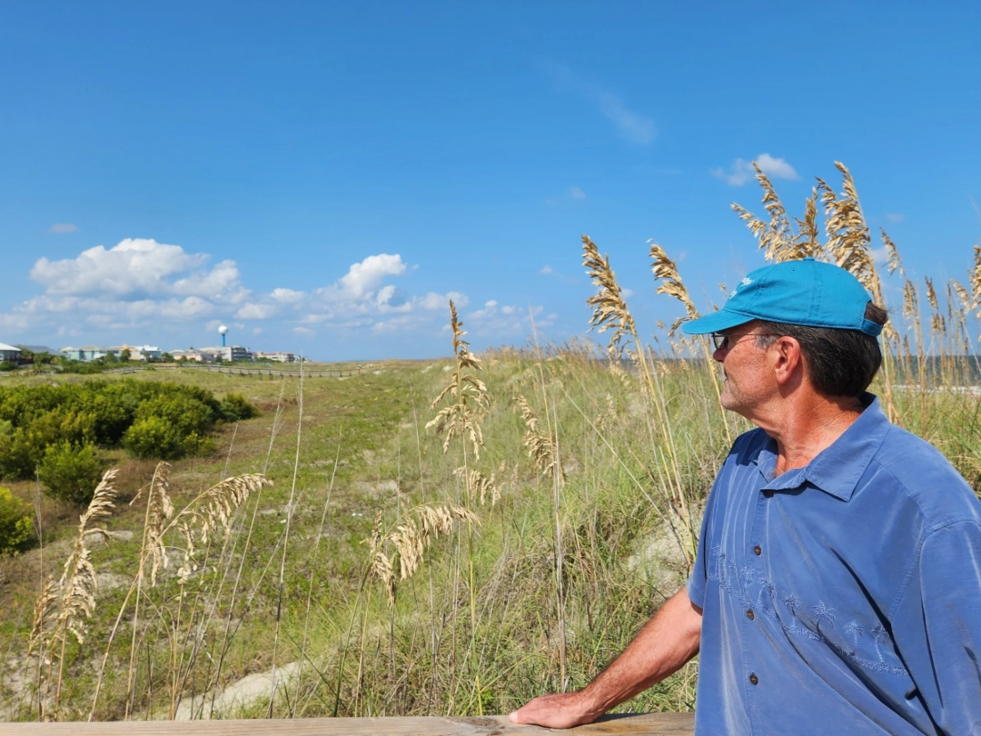 Alan Robertson looks out over the dunes on Tybee Island, Georgia.