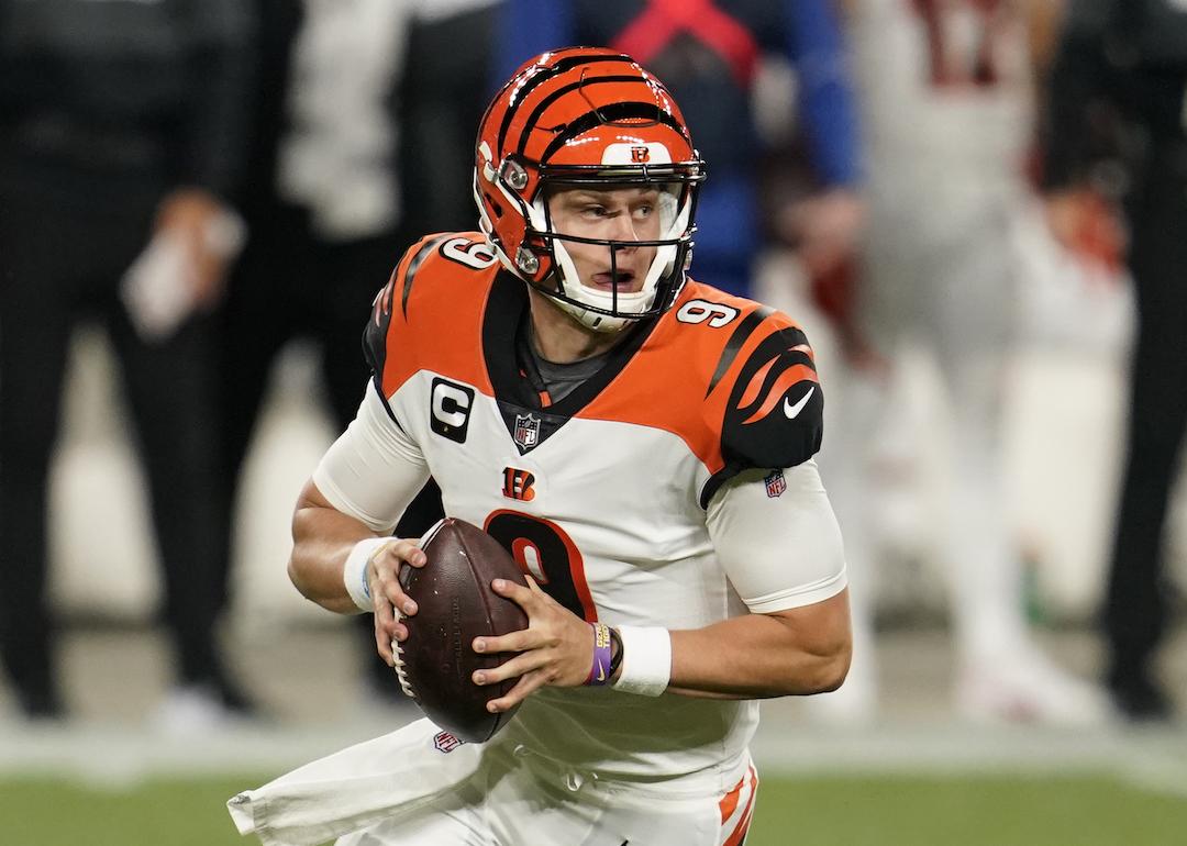 Joe Burrow #9 of the Cincinnati Bengals scrambles with the ball during an NFL game against the Cleveland Browns.
