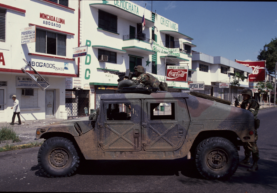 U.S. troops patrol the streets of Panama City in a military vehicle.