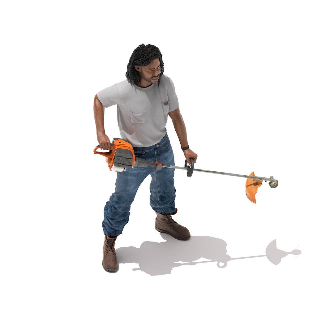 A man holds a weed whacker.