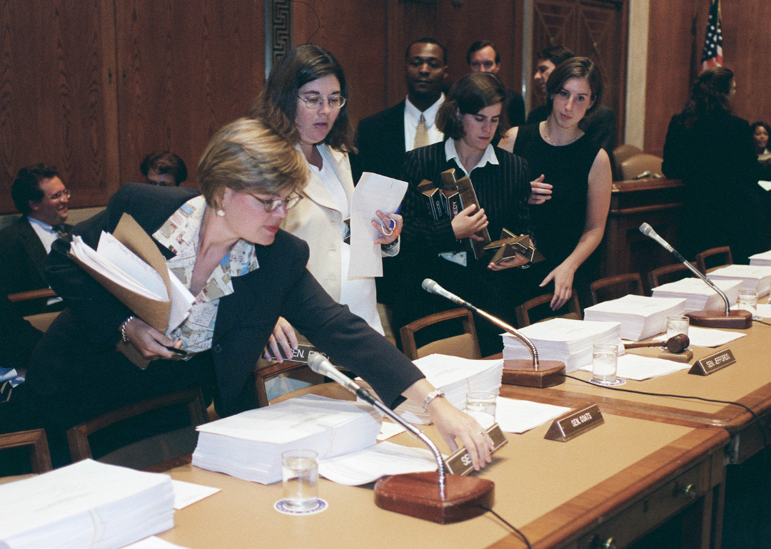 A staffer for Sen. Dan Coats, R-Ind., distributing name plates on the table in preparation for the joint conference committee meeting on the 1965: Higher  Education Act