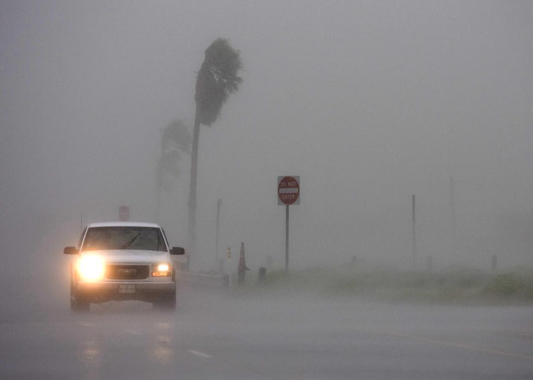 A driver makes their way through high winds and rain July 23, 2008 in San Benito, Texas