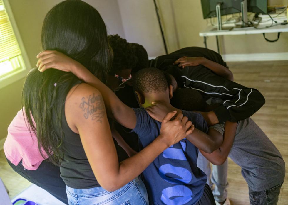 Rosalind Crawford and her five sons hug each other in their Greater St. Louis area home on June 10, 2023.