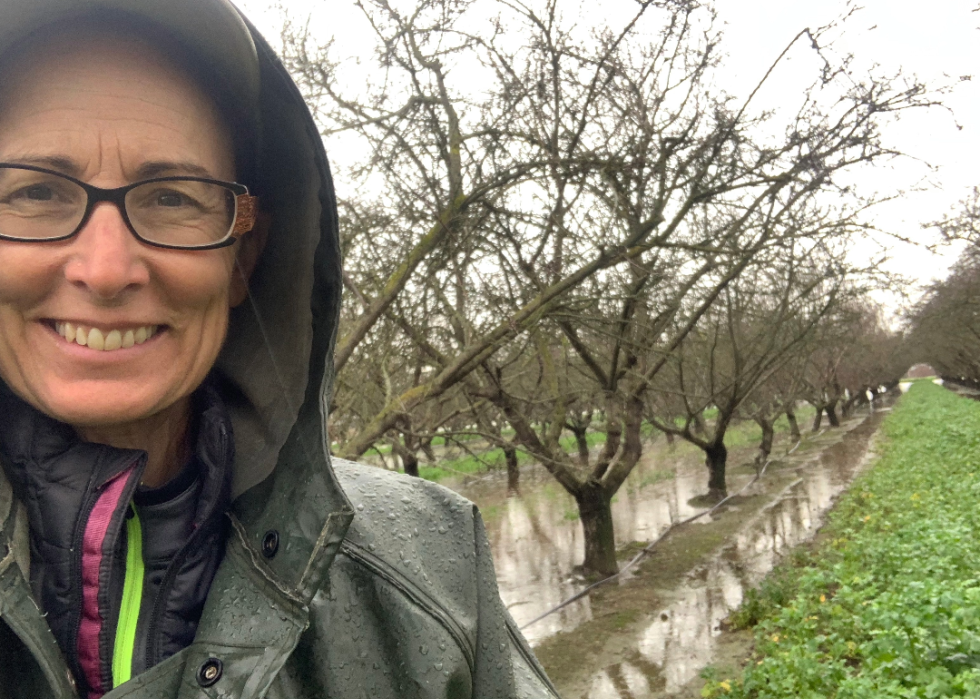 Christine Gemperle with her flooded almond farm during the rains of 2023
