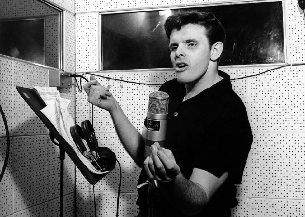 Del Shannon recording in the studio at a vintage microphone.