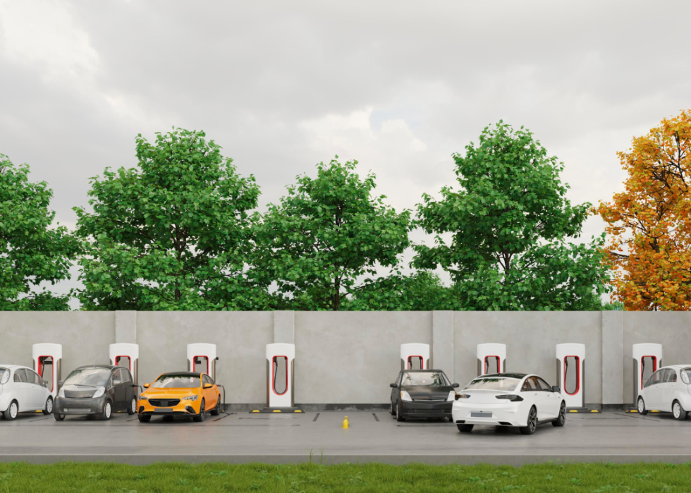 A row of EVs charging at charge stations