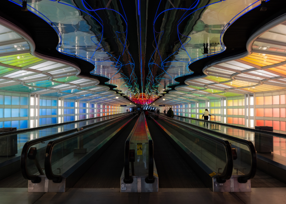 Lateral people mover at O'Hare International Airport under multicolored lights