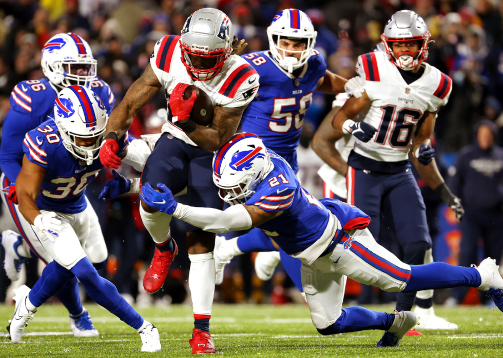 Jordan Poyer #21 of the Buffalo Bills attempts to tackle Brandon Bolden #25 of the New England Patriots during the game at Highmark Stadium on December 06, 2021 in Orchard Park, New York. 