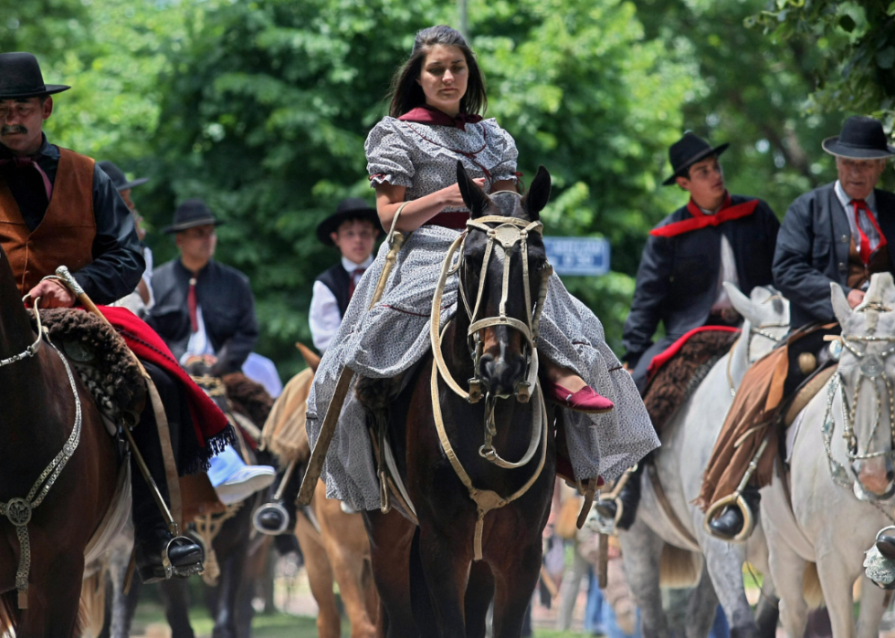 Several people riding horseback.