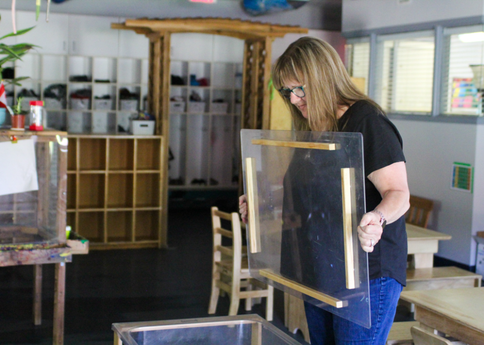 Lorraine Trulsen, owner of the Heritage Park Child Care Centre, prepares materials for children at her program in British Columbia. 