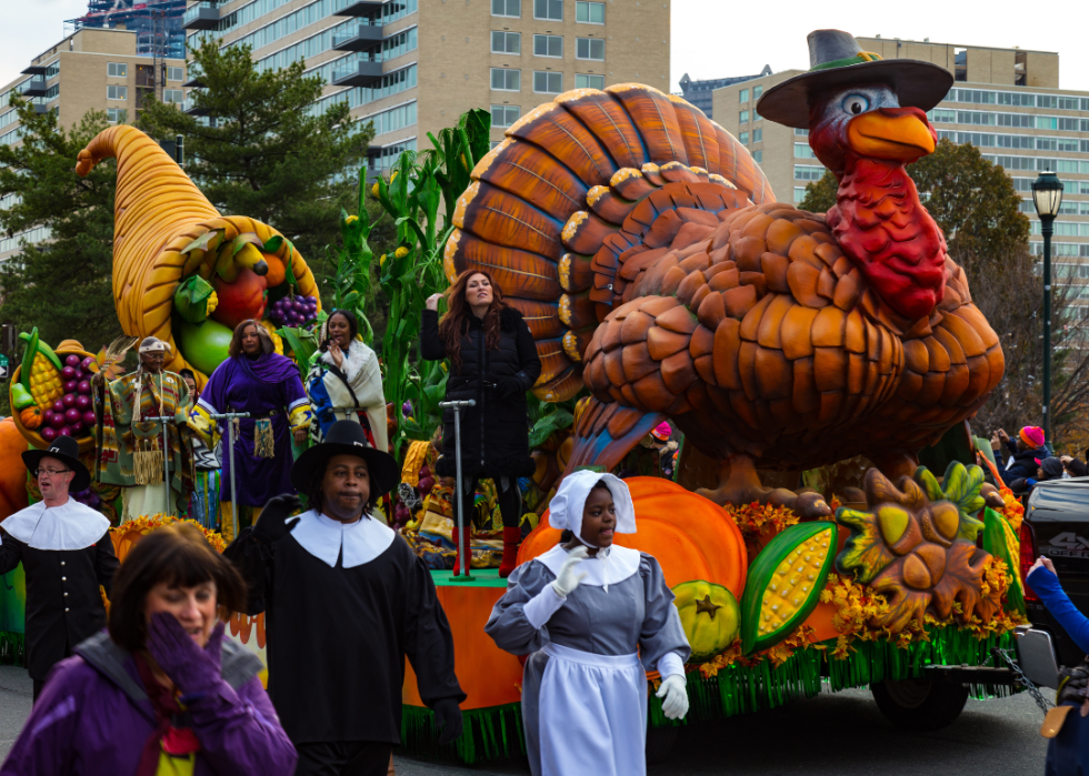 Pilgrims march alongside a turkey float in the annual Thanksgiving Day parade in the City of Brotherly Love.