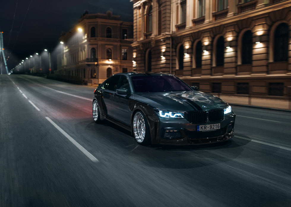 BMW 7 series G11 with carbon widebody kit drive fast at the night city