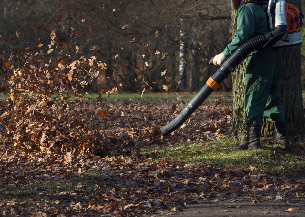 A worker using a leaf blower