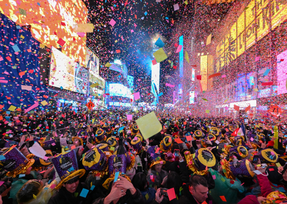 Fireworks and confetti fall over Times Square. 