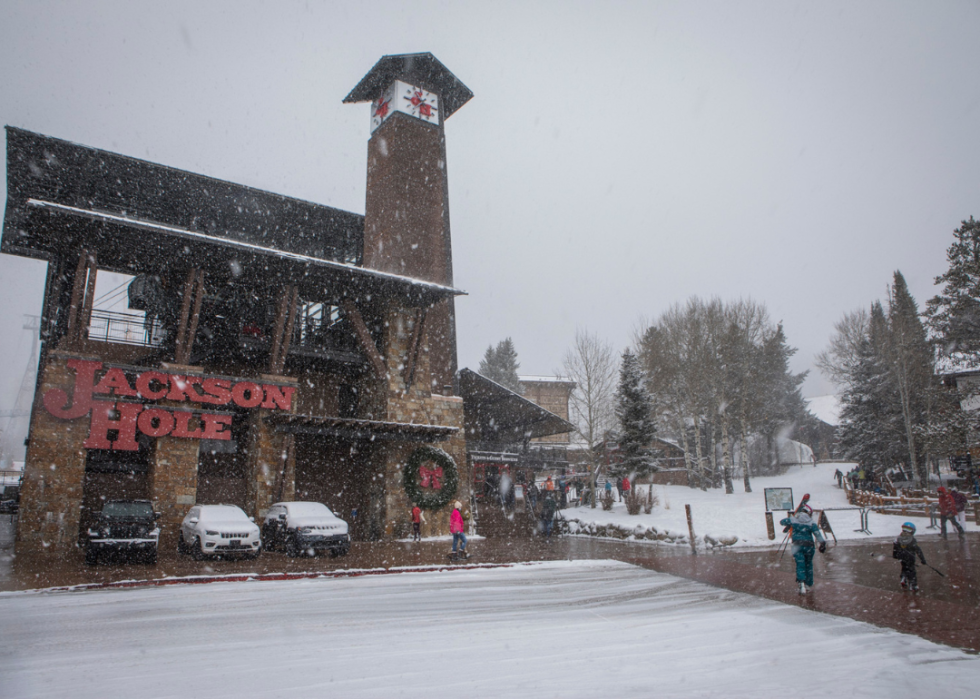 Skiers walk to the base of Jackson Hole Mountain Resort on Dec. 12, 2021 in Teton Village, Wyo.