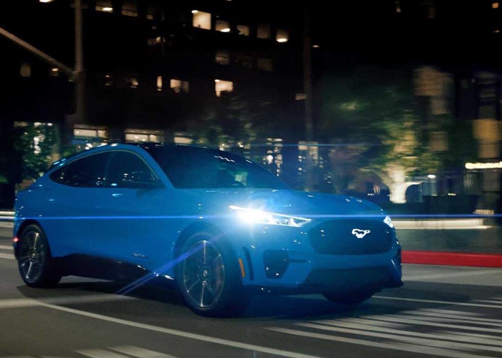 blue mach-e driving at night 