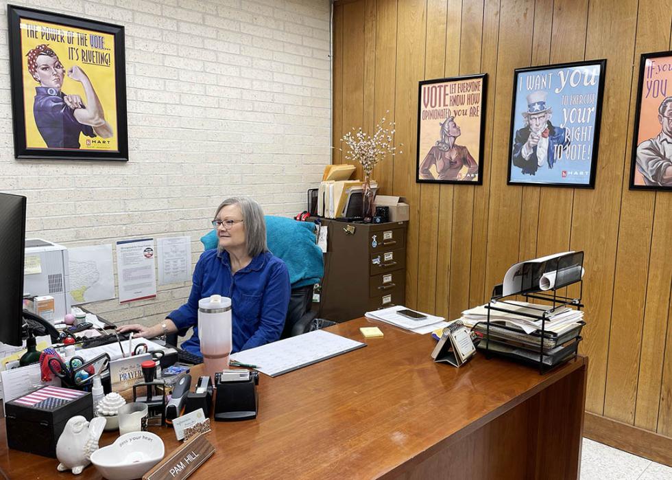 San Patricio County elections administrator Pam Hill works at her desk at the Elections Administration office in Sinton, Texas