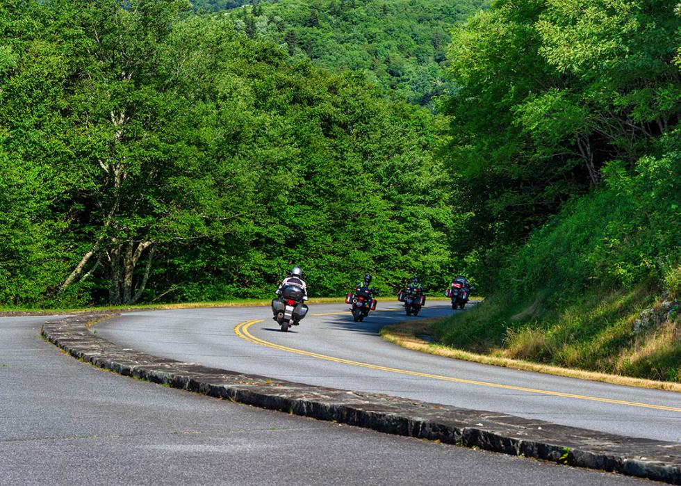 four motorcycle riders traveling on the blue ridge parkway