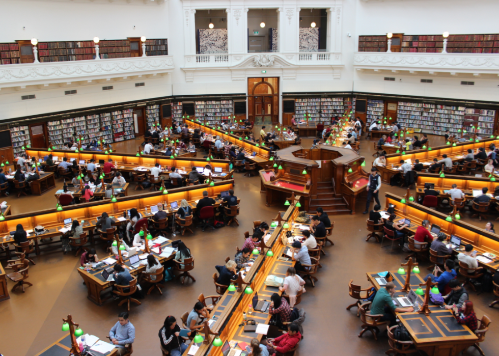 Overhead view of students working in a large university library.