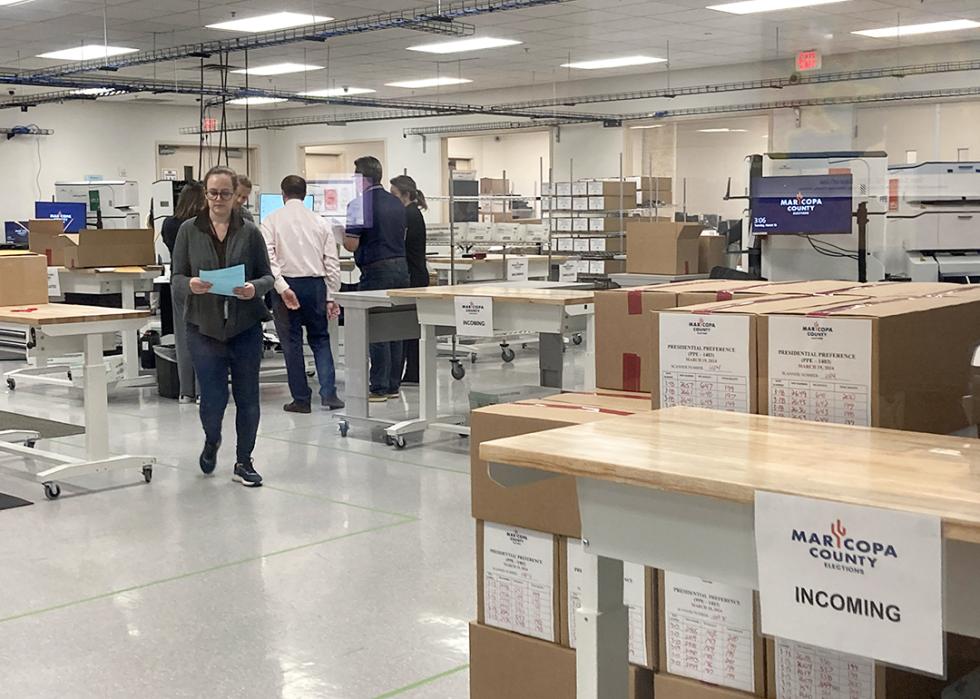 Maricopa County staff test the high-speed ballot-counting machines at the county's election headquarters before the March presidential preference election.