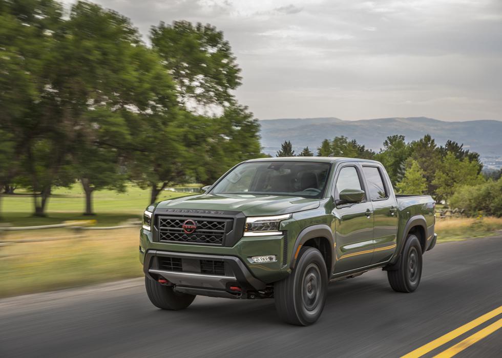 A military green 2022 Nissan Frontier is seen on action on the road.