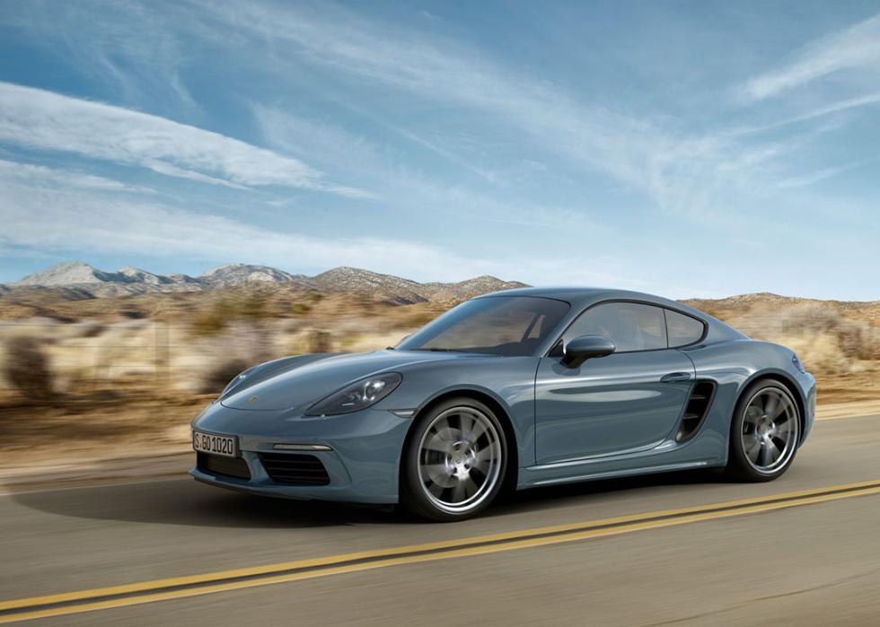 An agate gray metallic Porsche 718 Cayman on the road.