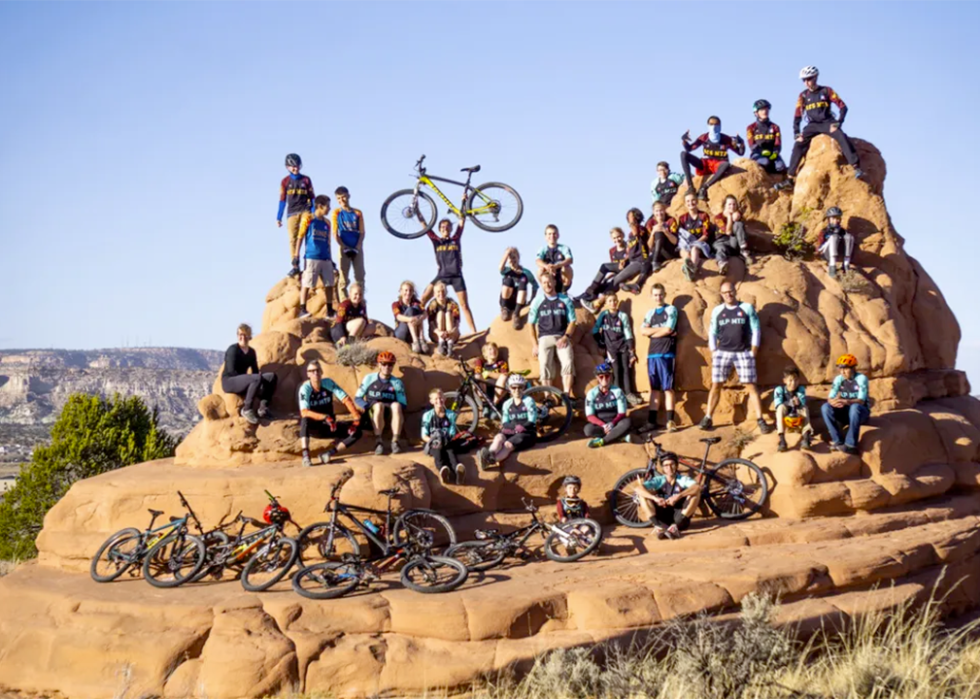 Group photo of Silver Stallion competition team posed on a rock formation.