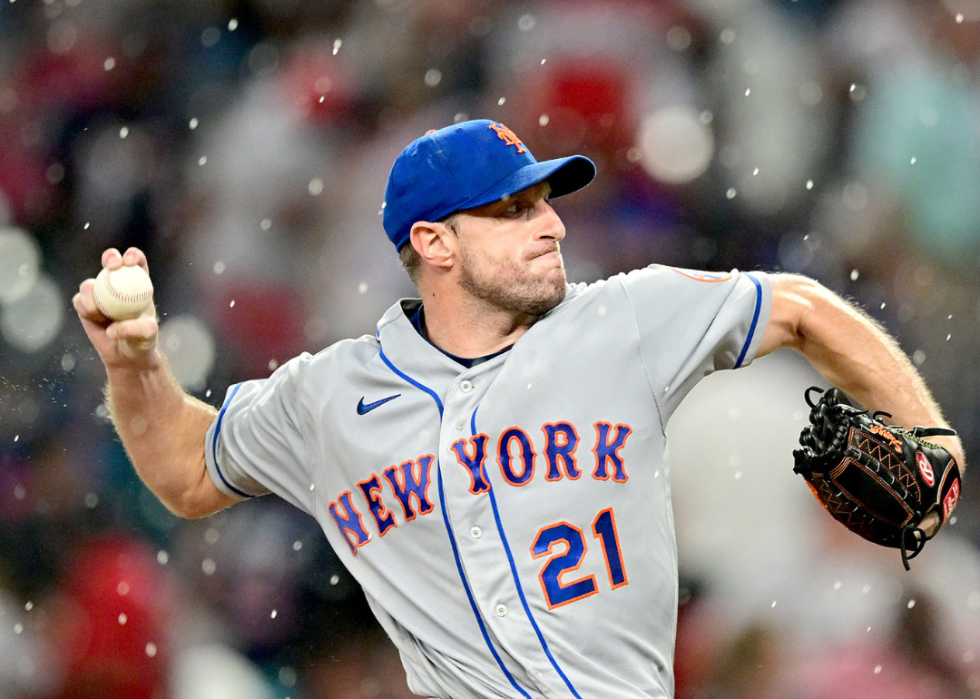 Max Scherzer #21 of the New York Mets pitches in the rain during the third inning against the Atlanta Braves at Truist Park on August 17, 2022 in Atlanta, Georgia. 