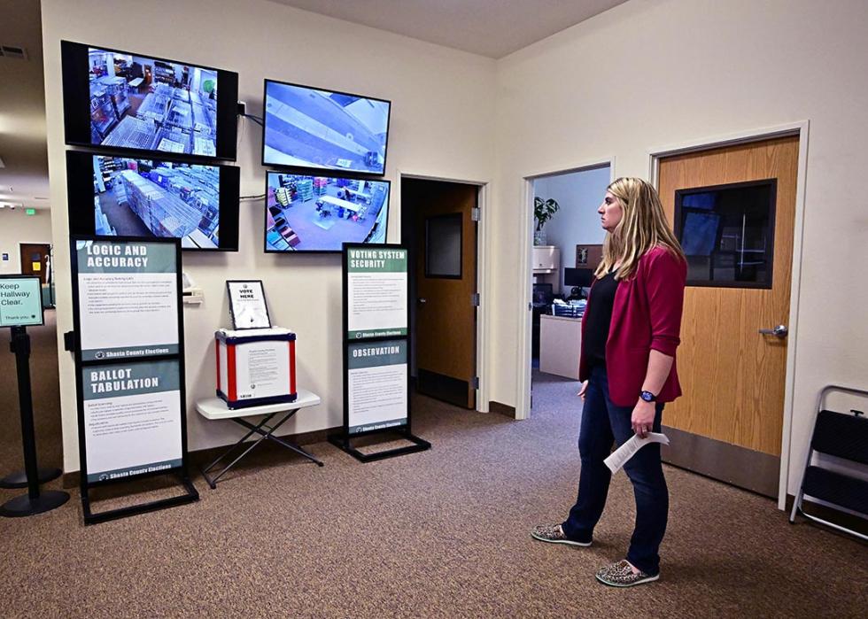 Joanna Francescut, Assistant Registrar of Voters, views screens offering a glimpse from security cameras at the Shasta County Clerk & Registrar of Voters office in 2024 in Redding in Northern Califonia's Shasta County.