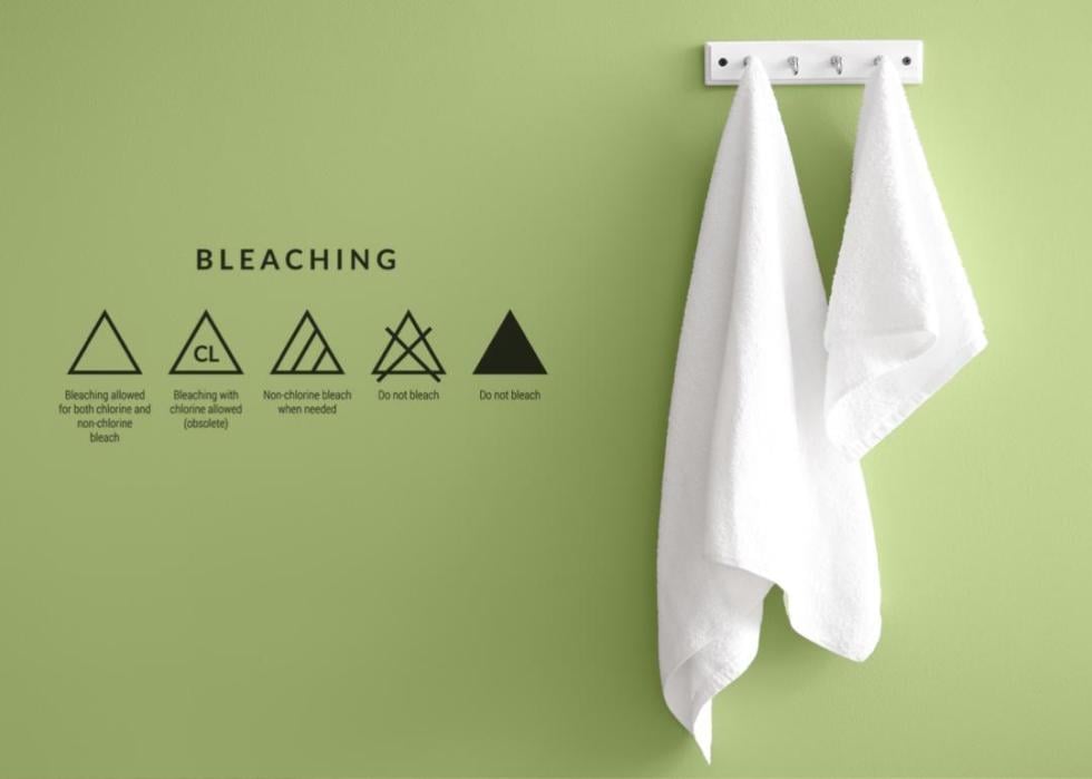 Bleaching care symbols and white towels.