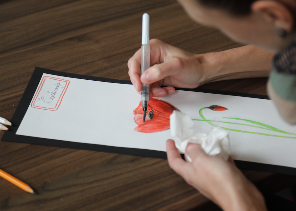 A participant drawing a flower during an art therapy session.