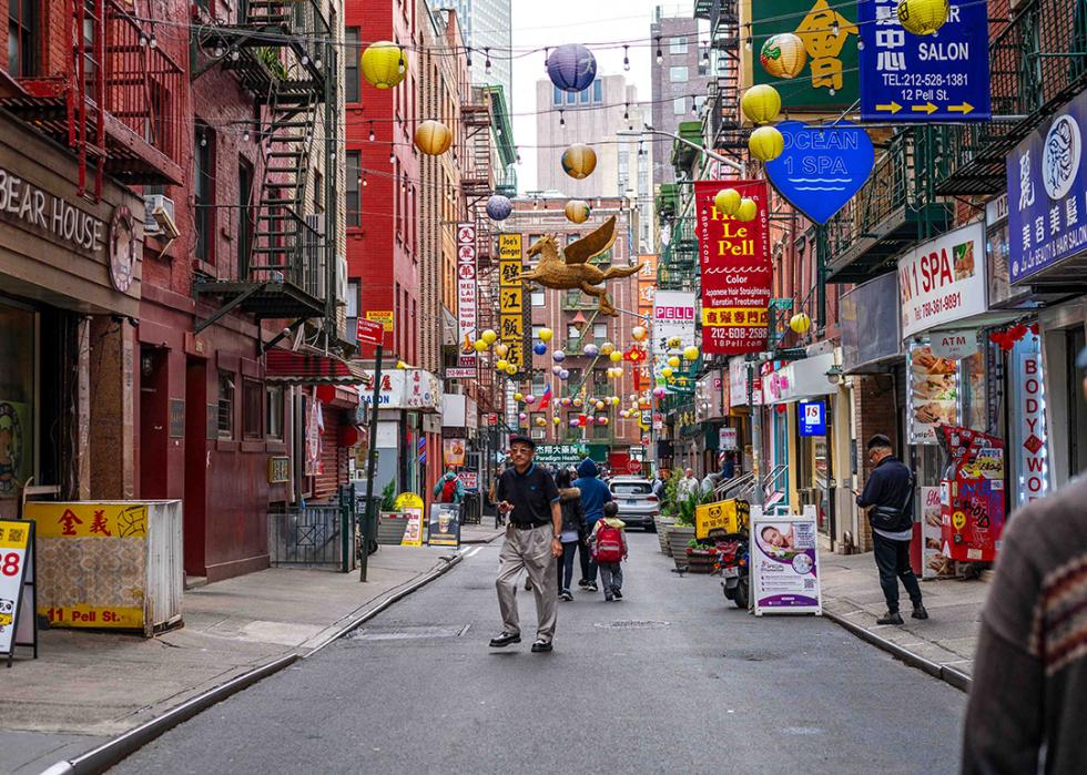 Pedestrians and businesses in a Chinatown street in New York City.