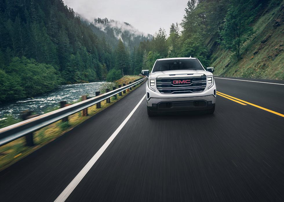 A front view of a white 2025 GMC Sierra 1500 on the road.