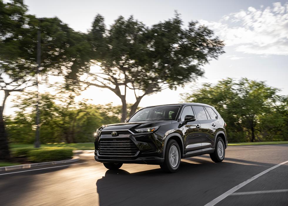 A 2025 black Toyota Grand Highlander on the road.