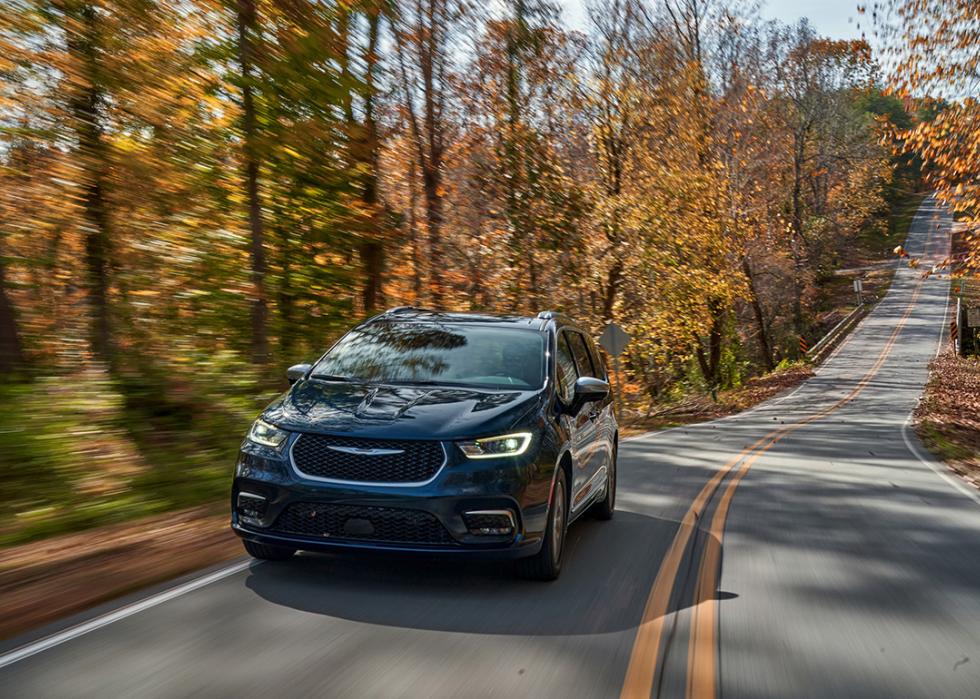 A black 2025 Chrysler Pacifica Hybrid on the road.