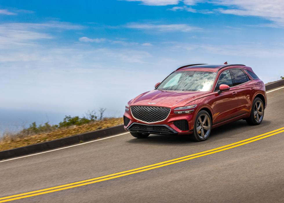 A red 2025 Genesis GV70 on the road.