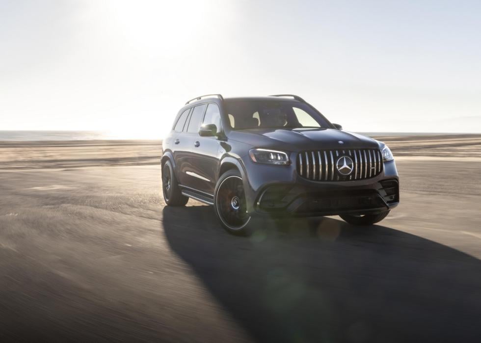 Dark Mercedes GLS on a dusty road.