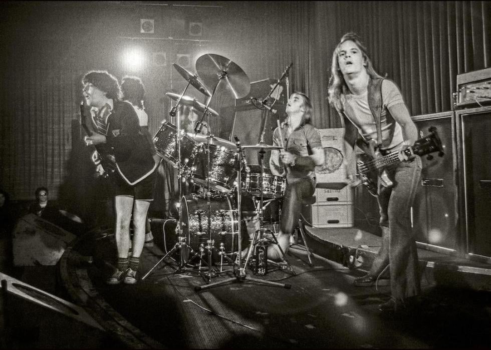 Angus Young and Mark Evans of AC/DC performing on stage in London in May 1976.