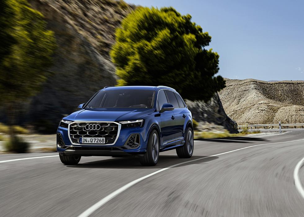 Blue Audi Q7 driving on the road.