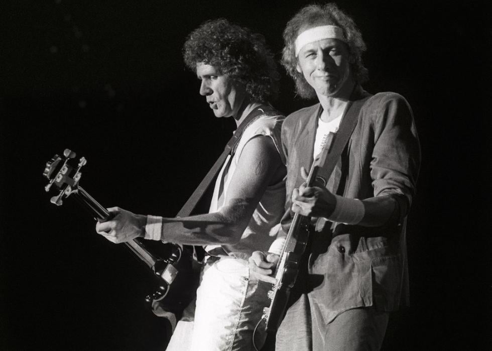 John Illsley ad Mark Knopfler from Dire Straits perform live on stage in Holland on May 25, 1985.