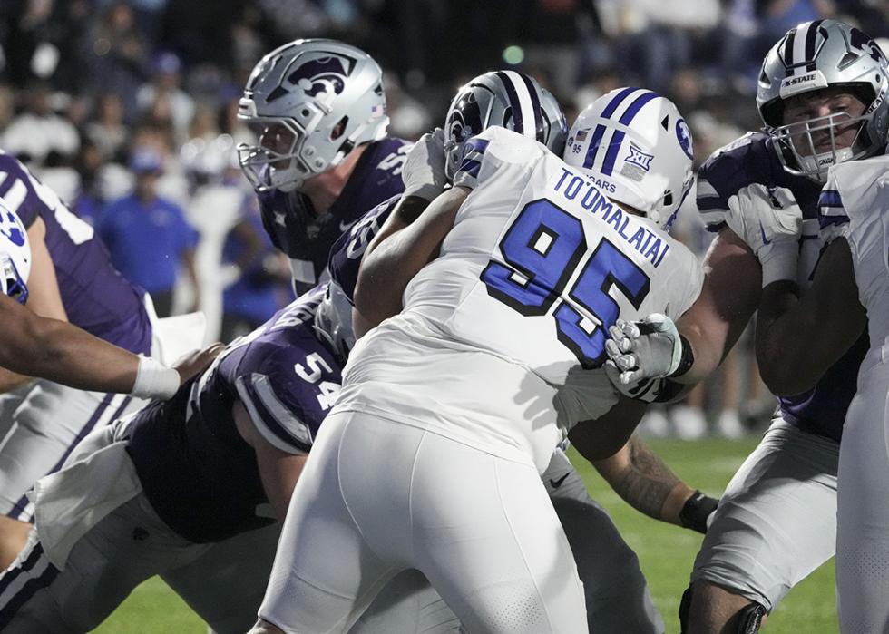 Luke To'omalatai (95) defends during the game between the Brigham Young Cougars and the Kansas State Wildcats in Provo.