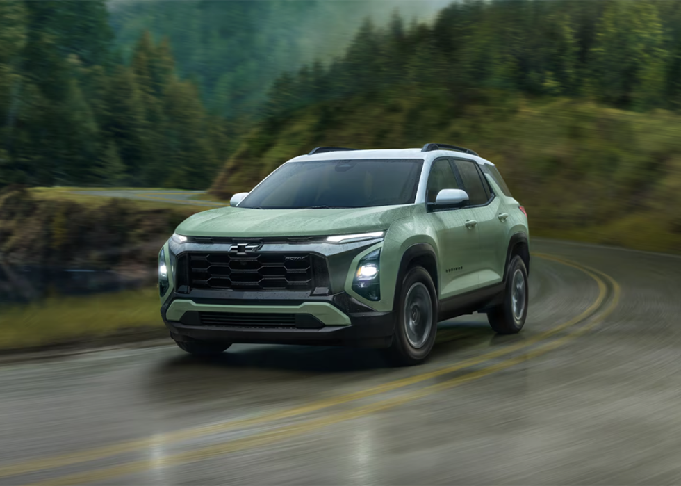 A green 2025 Chevy Equinox on the road.