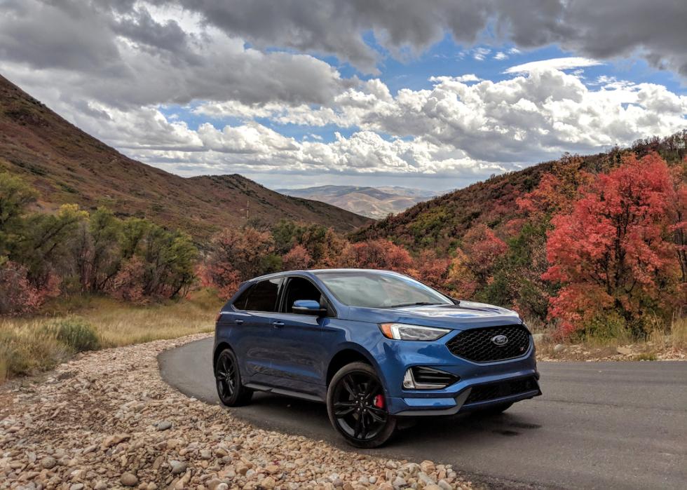 A blue Ford Edge SUV in the mountains.