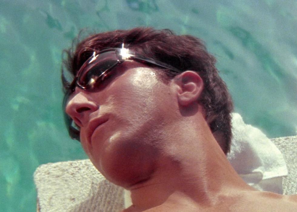 Dustin Hoffman lays in the pool.