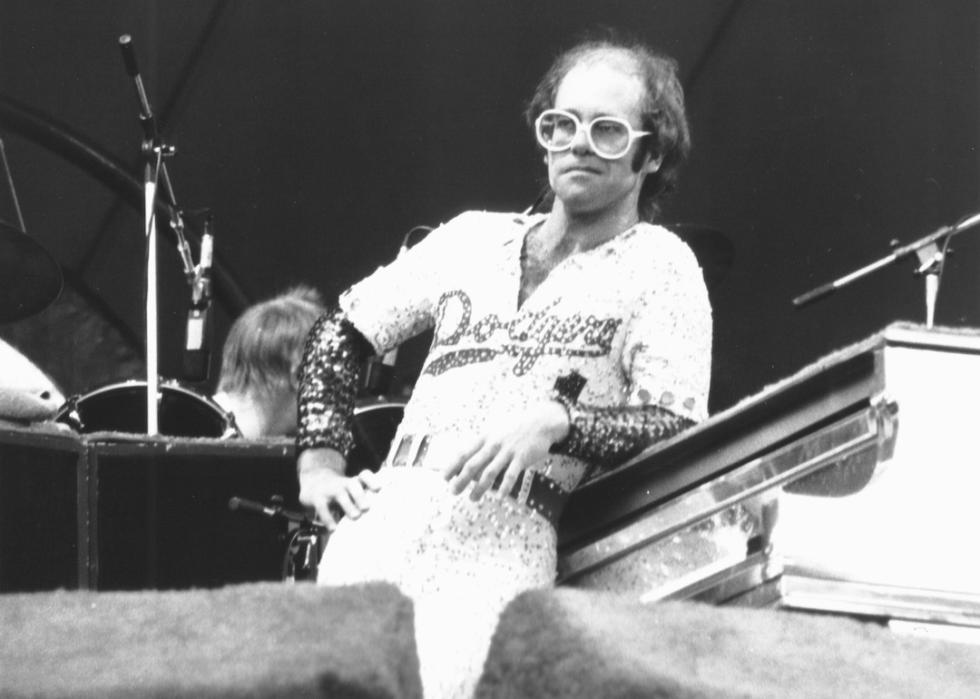 Elton John performs on stage in 1975 at Dodger Stadium.