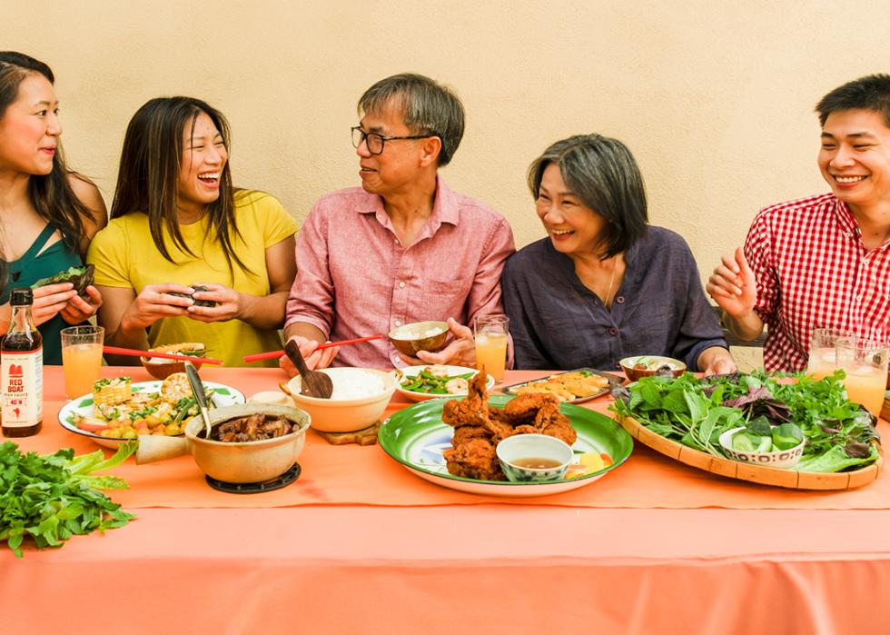 The Pham family photographed enjoying a feast.