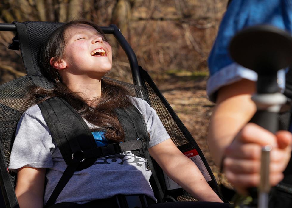 Luci Wilde reacts as she rides in a hiking cart designed by her dad, LJ Wilde.