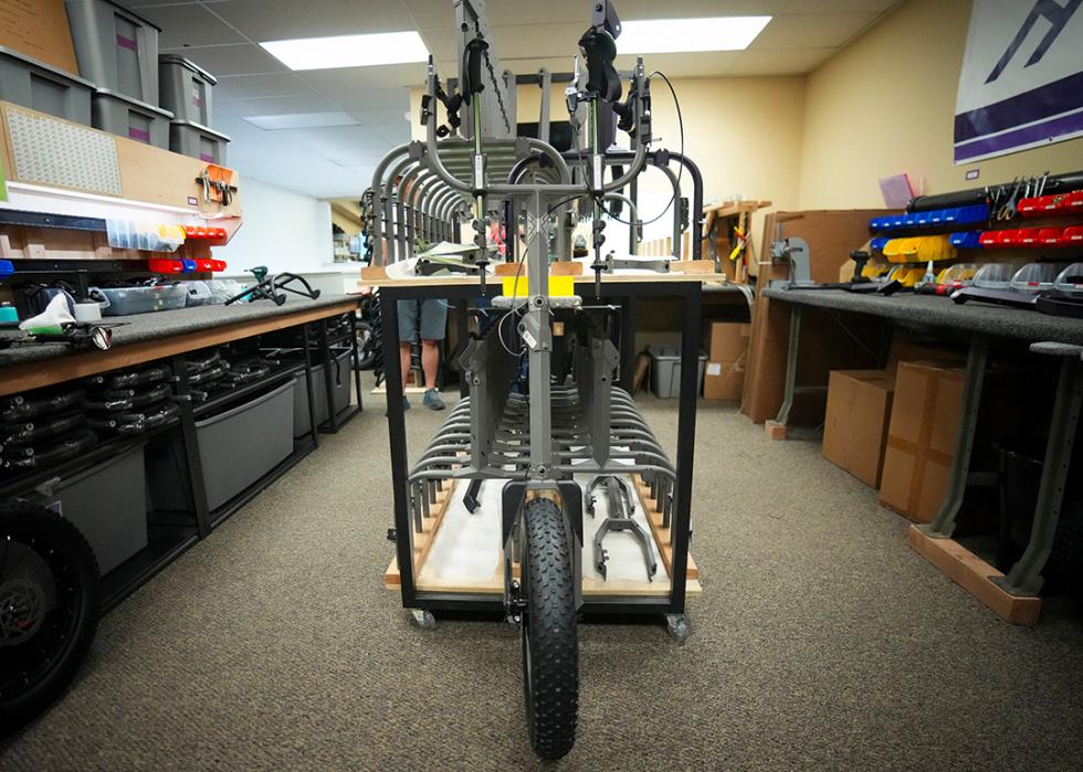 Part of a hiking cart designed for accessibility leans against a table in the workshop for Huckleberry Hiking in North Logan.