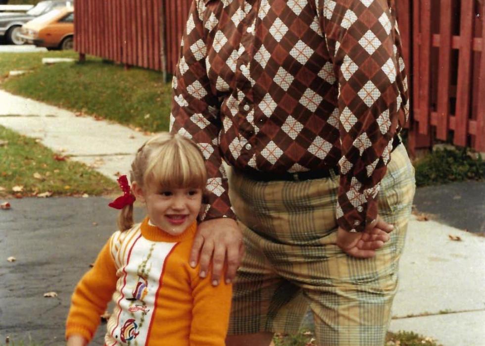 John Candy and his daughter standing in some grass
