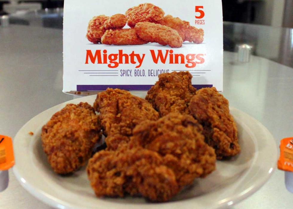Some McDonald's Mighty Wings on a plate in front of the original packaging